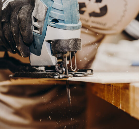 close-up of jigs machine by sawing wooden plate